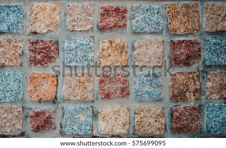 The texture of colorful square stones in the concrete. Royalty-Free Stock Photo #575699095