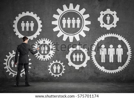 Businessman standing with back and drawing concept of teamwork and cooperation