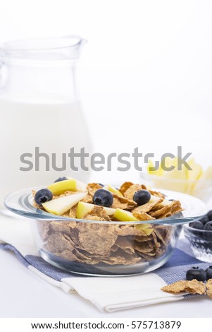 Muesli with blueberry and apple. Jug with milk. Isolated on white background. / Muesli with blueberries and apples. Jug with milk. On a white background / Nadale
