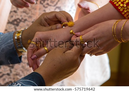 father gives his daughter's ring and wear it on hand at a wedding ceremony (soft focus)