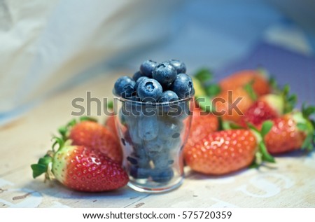 Raw fruit and berries platter, strawberry, blueberry, blackberries, red currants, grapes, selective focus