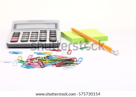 calculator, notebook with a pen
