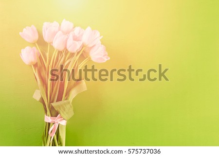 Bouquet of pink tulips on a green background.