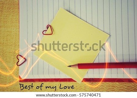 Note paper and a paper clip in the shape of a heart: the concept of Valentine's Day - February 14