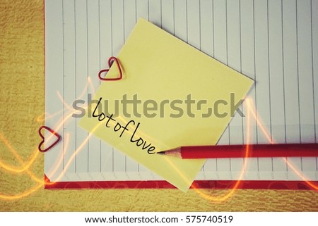 Note paper and a paper clip in the shape of a heart: the concept of Valentine's Day - February 14