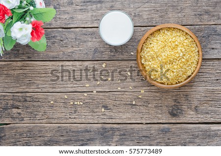 Soy Milk with some Seeds (close-up shot) on wooden background