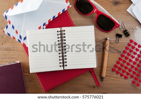 wooden desktop with blank notebook paper background, writing concept
