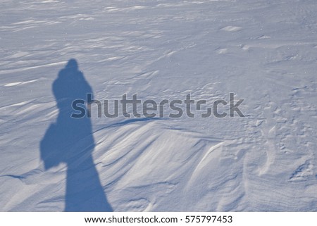 Shadow on the snow. Bright frosty winter day. Frozen River Volga. The minimalist landscape. Ice desert. Ulyanovsk, Russia.