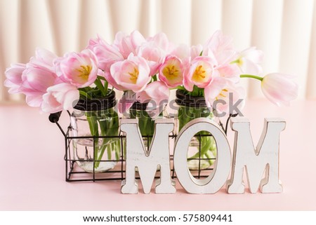 Light pink tulips on a pink background.