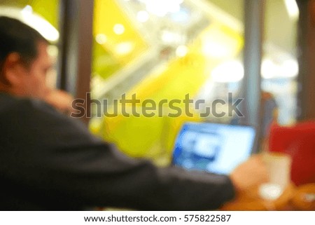 Picture blurred  for background abstract and can be illustration to article of Business man working laptop in coffee shop