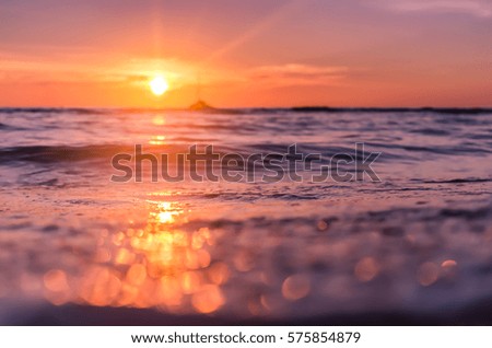Blur tropical sunset beach with bokeh light wave abstract background. Copy space of outdoor summer vacation and business travel adventure concept. Vintage tone filter effect color style.