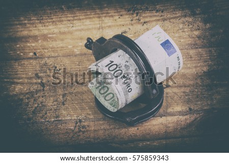 Handcuffs and euro bills