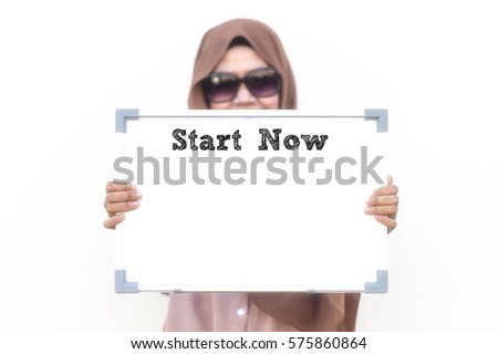 Start Now : Typed Words on a whiteboard with blur image of Asian young lady wearing muslimah attire. Motivational concept for business, living and financial.