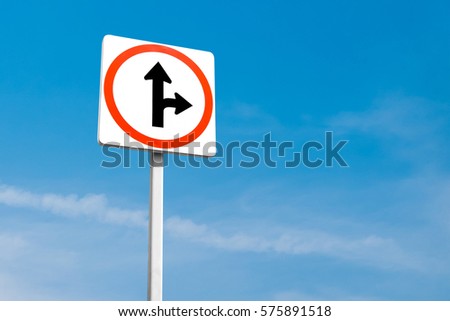 go straight or turn right direction traffic sign on blue sky background