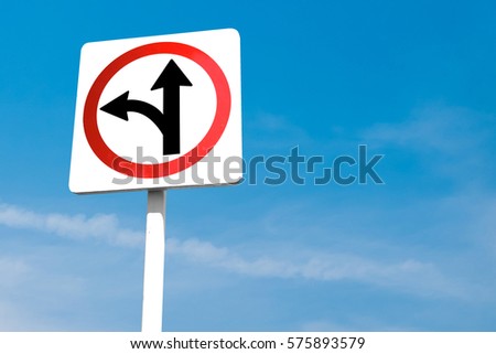 go straight or turn left traffic sign on blue sky background