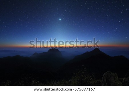 Beautiful scenery of the starry sky and zodiacal light at night of Doi Luang Chiang Dao at Chiang Mai province in Thailand. Long exposure shooting and high iso used make this photo have noise