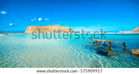Amazing panorama of Balos Lagoon with magical turquoise waters, lagoons, tropical beaches of pure white sand and Gramvousa island on Crete, Greece Royalty-Free Stock Photo #575909917