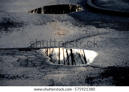 Puddle on the road Royalty-Free Stock Photo #575921380