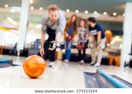 Friends enjoying recreational  bowling at club