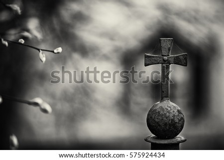 Black and white art photo mood park railing with a cross Fok bokeh.outdoors