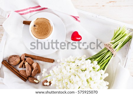 Two cups of coffee - espresso, heart and bouquet of flowers - lilies of the valley on white background. romantic breakfast for my birthday, Valentine's Day.
