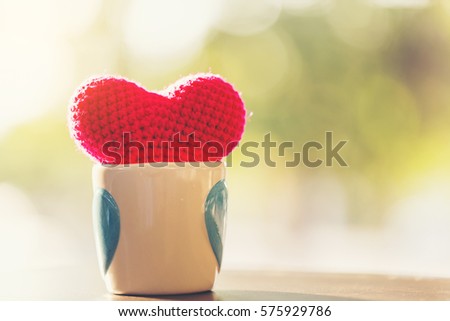 Soft focus of Valentine decorative with red heart knitting shape on wooden table ,Image for happy valentine day concept.