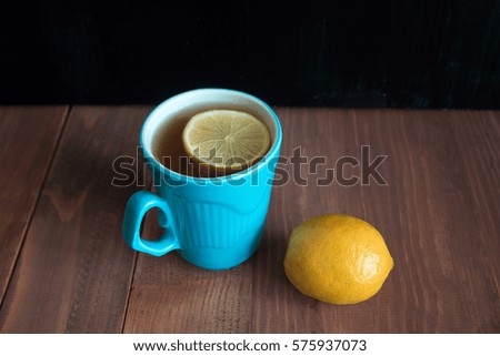 lemon tea in  blue cups on a wooden table