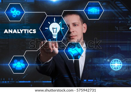 Business, Technology, Internet and network concept. Young businessman working on a virtual blackboard of the future, he sees the inscription: analytics