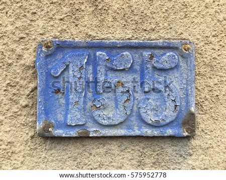 Vintage grunge square metal rusty plate of number of street address with number 155 closeup