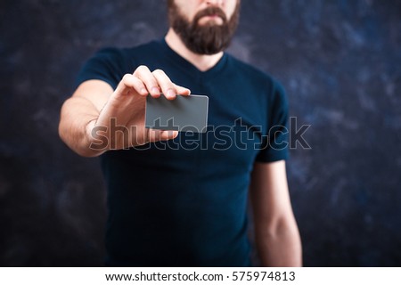 young bearded man holds a business card, business card template
