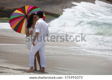 Dating on the beach with umbrella in Rio de Janeiro