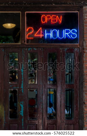 Open 24 Hours neon sign on a vintage restaurant