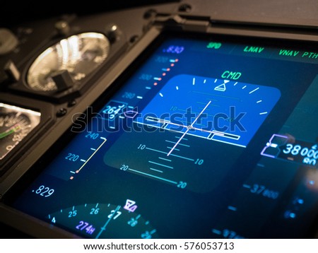Airplane electronic primary flight instrument display in modern grass cockpit aircraft shown autopilot control aircraft to cruise at altitude of 38,000feet Royalty-Free Stock Photo #576053713