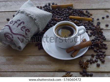 cup of coffee, coffee beans, cinnamon and star anise