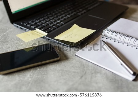 Yellow sticky note on a laptop computer reminding of a appointment with client, angle view
