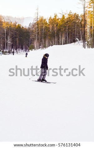 Athlete skiing down the snowy road