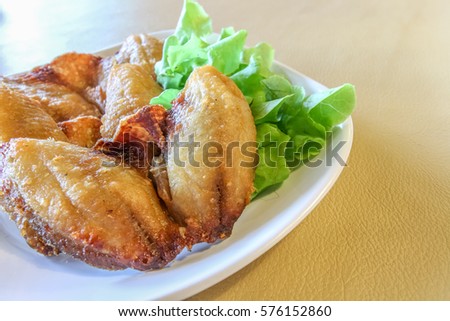 Deep fried fish on the white plate with copy space