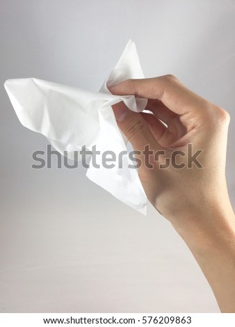 a hand holding white napkin Royalty-Free Stock Photo #576209863