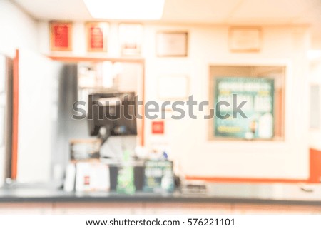 Blurred image of an empty office counter service. Abstract background cashier/checkout with monitor in an small modern automotive oil change shops in America.
