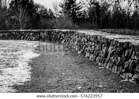 Winding Stone Wall II: A winding stone wall in Discovery Park. Royalty-Free Stock Photo #576223957