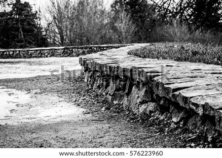 Winding Stone Wall: A winding stone wall in Discovery Park. Royalty-Free Stock Photo #576223960