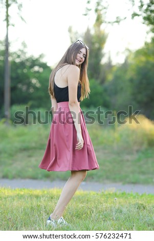 Woman with long hair and beautiful eyes on a green background shows the different human emotions. Lady portrays dancing, jumping, fun, happiness, smile