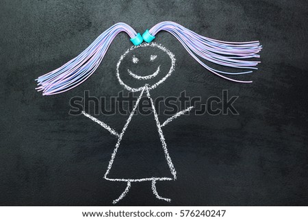 Painted girl with pigtails on a blackboard