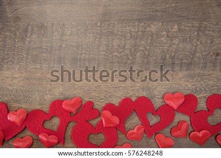 Variety of hearts on a wooden background with copy space