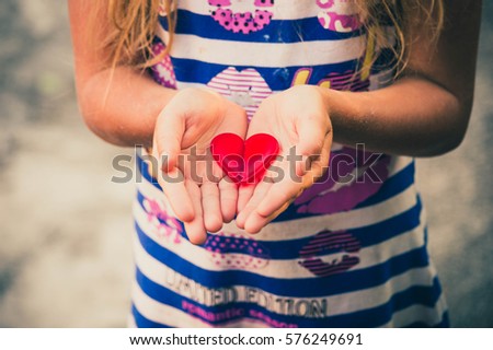  Girl is holding heart in her hands