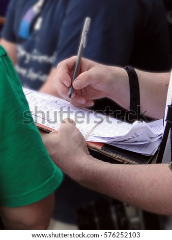 Man signing a petition for a public referendum in Seattle
					 Royalty-Free Stock Photo #576252103
