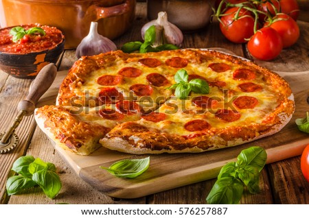 Homemade cheese pizza with salami, delicious pizza with cheddar