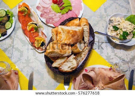 Table with abundant food - top view. Festive food is served. Gluttony is human consumption of foods in large quantity.