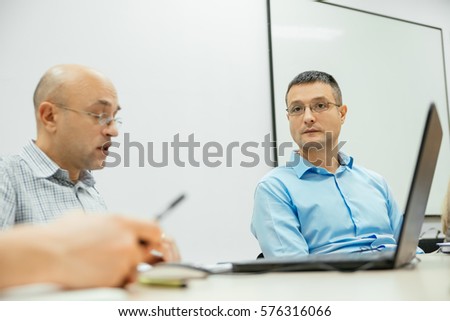 Businessmen In A Meeting Talking