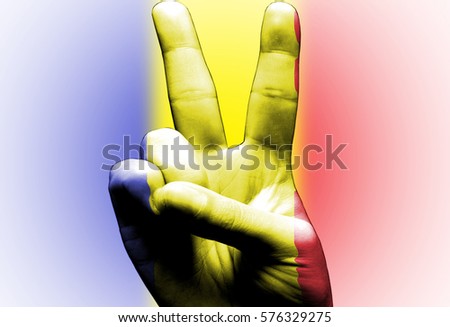 v sign hand painted with romanian flag over the romania flag